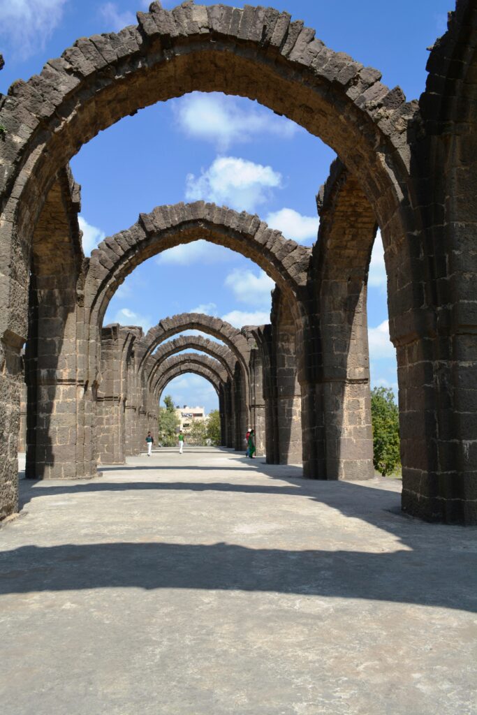 Majestic stone arches in Vijayapura, India, showcasing architectural history and charm.